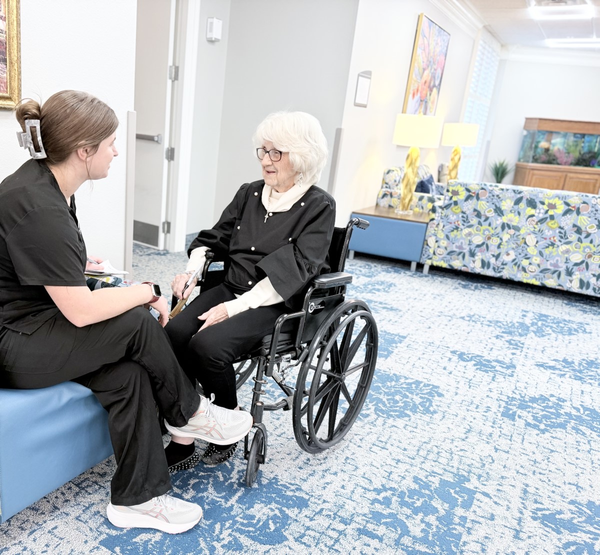 female patient in wheelchair with female nurse