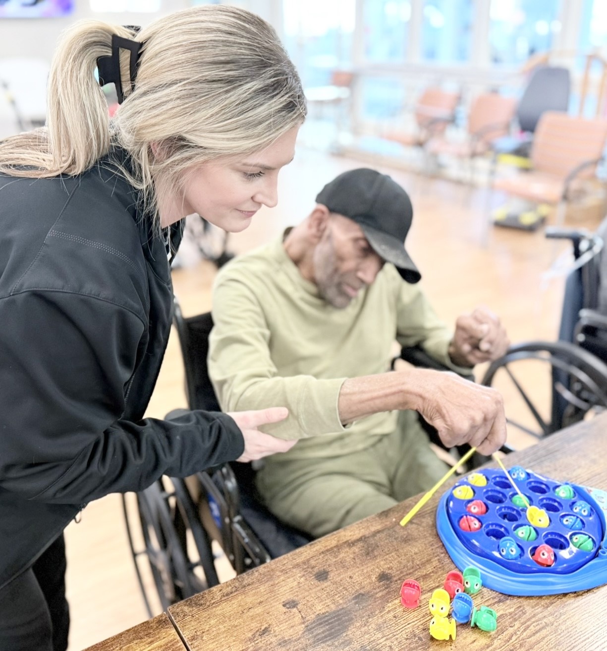 male patient playing dexterity fish game