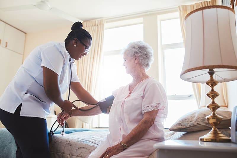 A nurse examining a patient at a nursing & rehabilitation center in Bossier City, LA