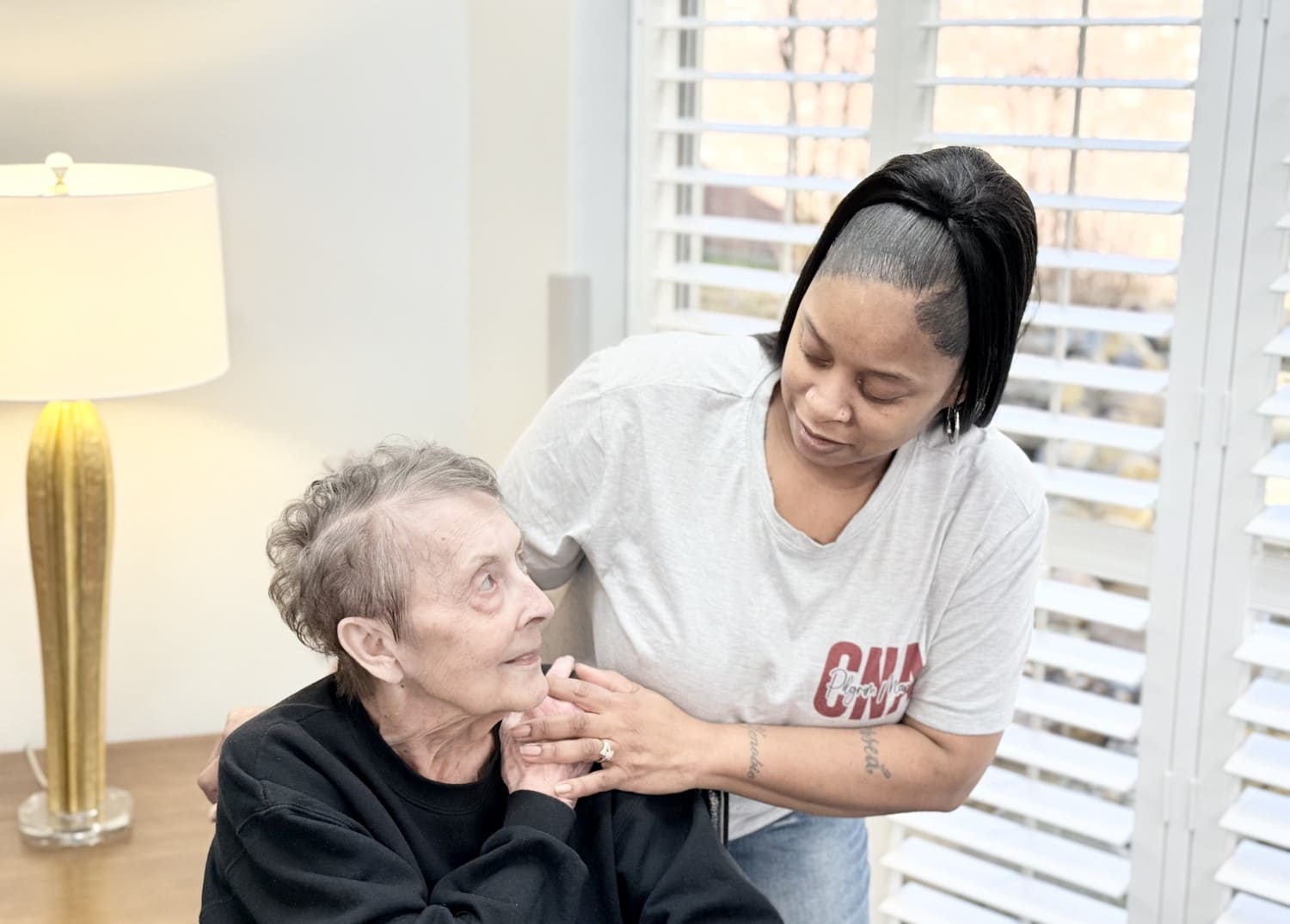 A woman consoling a patient at a nursing & rehabilitation center in Bossier City, LA