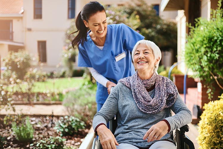 A respite care nurse wheels a patient around outside a nursing care facility in Bossier City