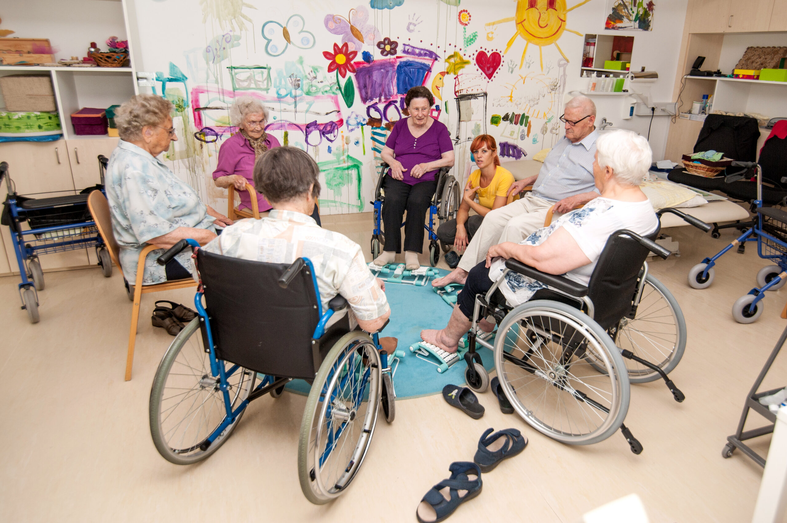 High Angle View Of Seniors Having Foot Massage Using Foot Roller
