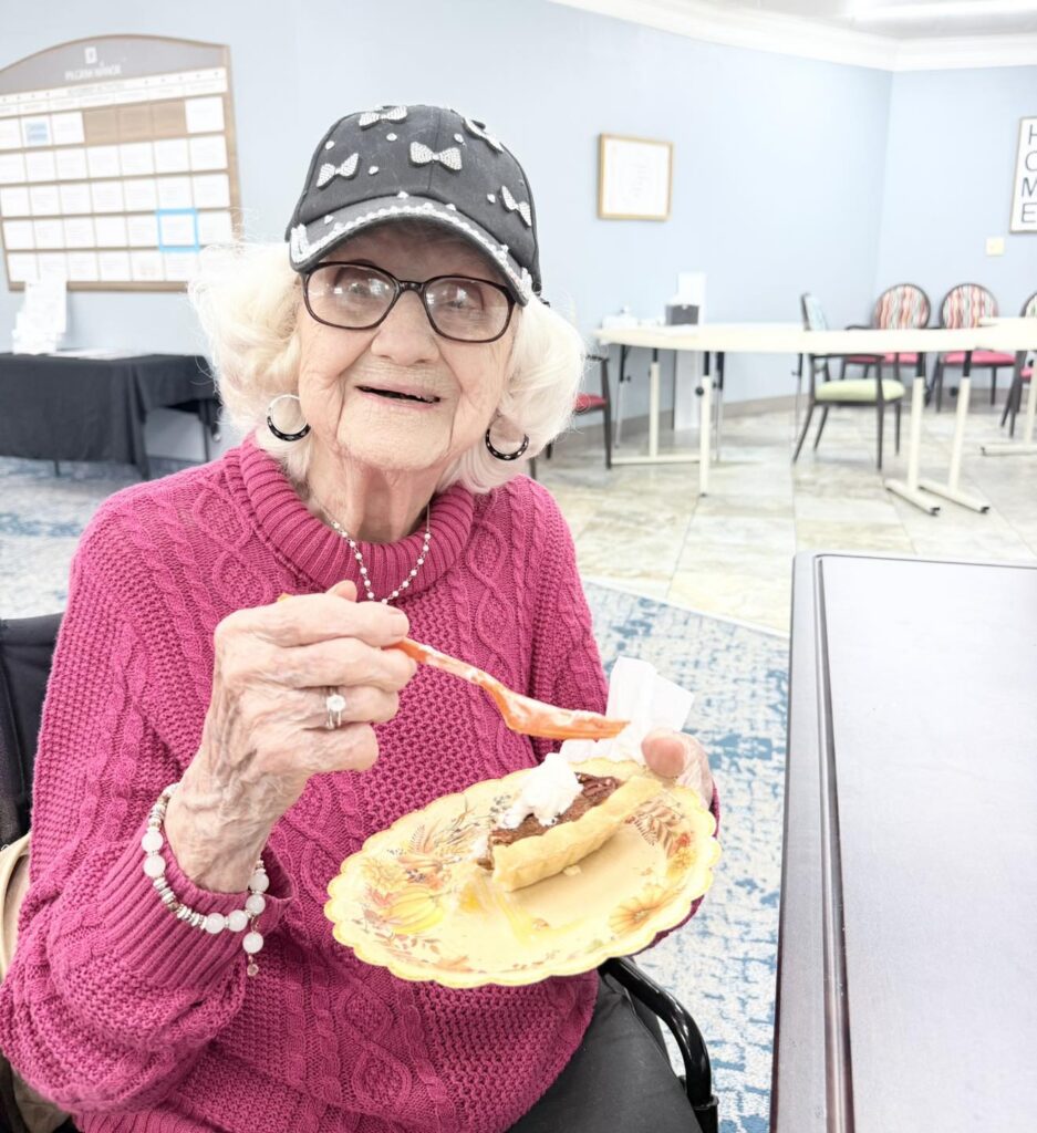 Resident enjoying a slice of pie in the Pilgrim Manor dining room