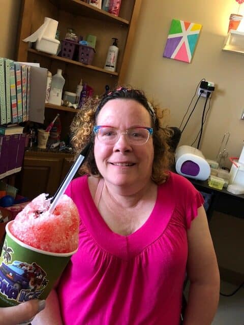 Staff serving ice cream to a resident at Pilgrim Manor