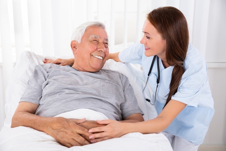 Long-term care nurse assisting a senior patient