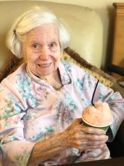 Resident enjoying ice cream at a Pilgrim Manor event
